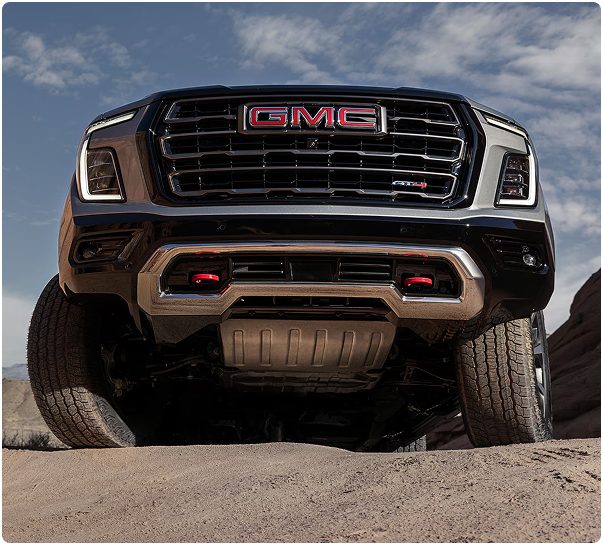 Low-angle view of the GMC Yukon AT4 Ultimate grille, skid plate and red recovery hooks
