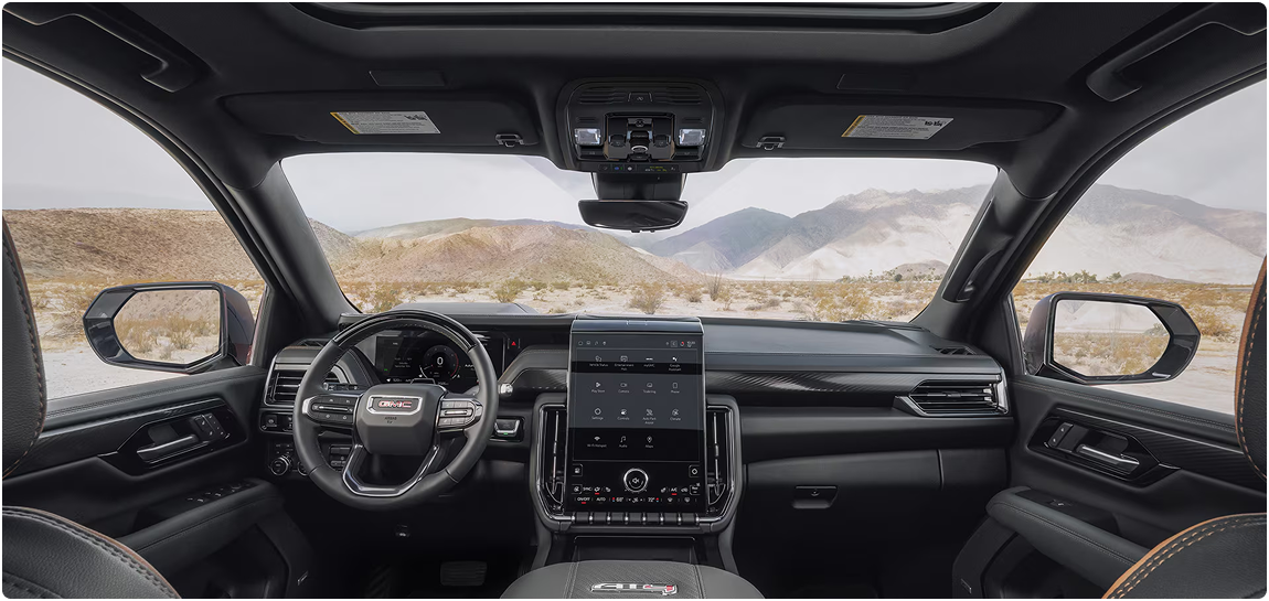 GMC Yukon AT4 dashboard and portrait touchscreen with a desert view through the windshield
