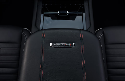 AT4 Ultimate badge on a black leather seatback with red stitching