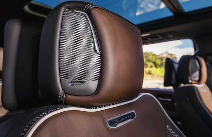 Brown leather Yukon Denali Ultimate front seat with a Bose headrest speaker under the panoramic sunroof
