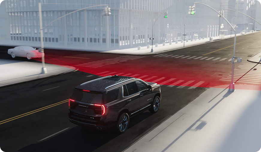 Illustration of a Yukon at a city intersection detecting cross traffic in a red sensing zone