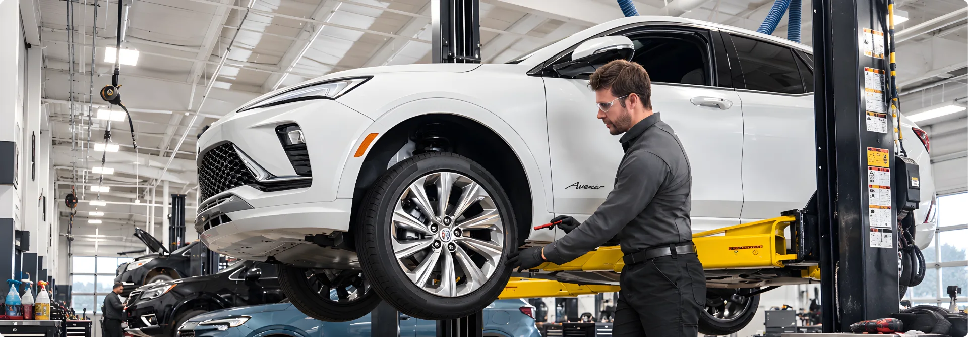 The Phillips Buick GMC service department with several vehicles raised on lifts and technicians at work